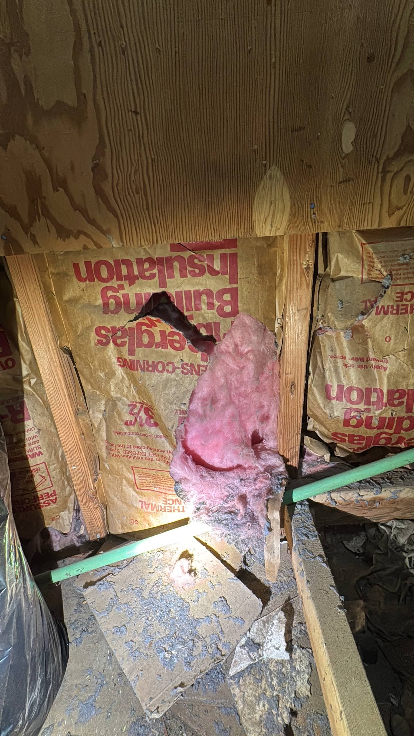 Fiberglass insulation being removed and replaced to improve energy efficiency